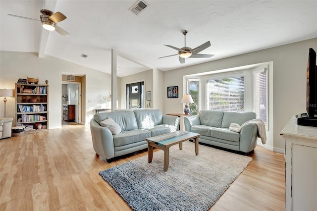 living room with lofted ceiling with beams, ceiling fan, and light wood-type flooring