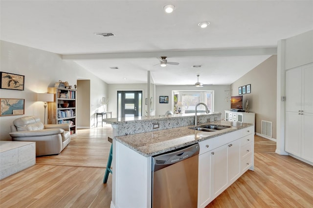 kitchen featuring white cabinetry, sink, vaulted ceiling with beams, stainless steel dishwasher, and an island with sink