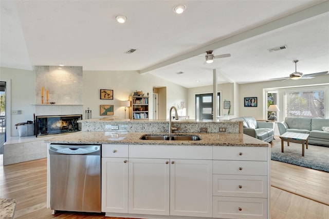 kitchen with dishwasher, white cabinets, lofted ceiling with beams, sink, and light wood-type flooring