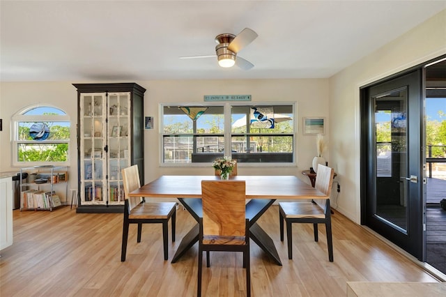 dining space with french doors, light wood-type flooring, and ceiling fan