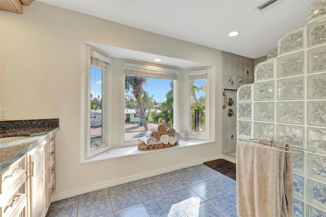 bathroom featuring vanity and a tile shower