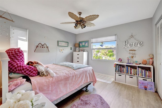 bedroom featuring a closet, light hardwood / wood-style flooring, and ceiling fan