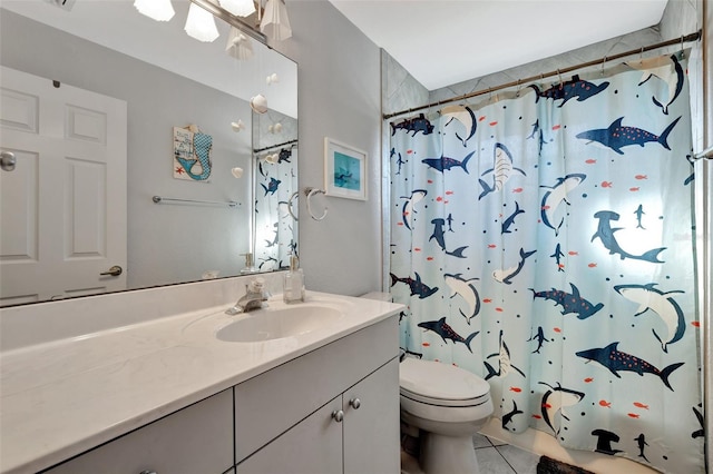 bathroom featuring tile patterned floors, vanity, and toilet