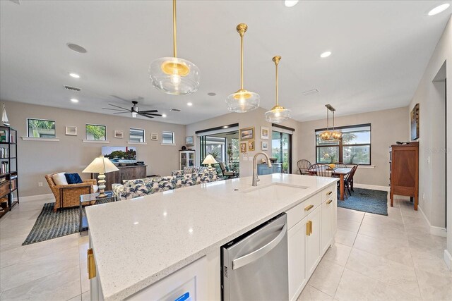 kitchen featuring white cabinetry, dishwasher, sink, light stone counters, and pendant lighting