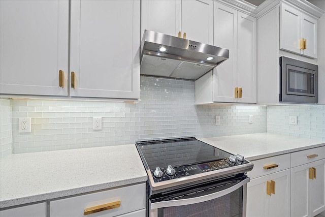 kitchen with stainless steel electric stove, light stone countertops, backsplash, and built in microwave