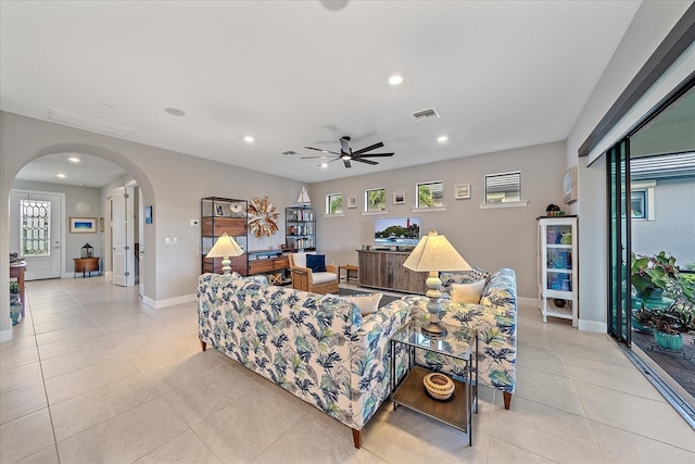 tiled living room with ceiling fan