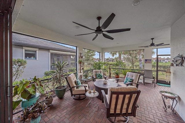 sunroom featuring ceiling fan