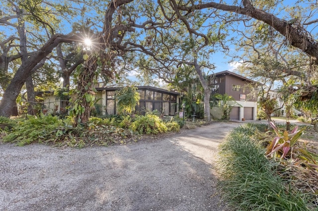 view of front of property with a sunroom and a garage