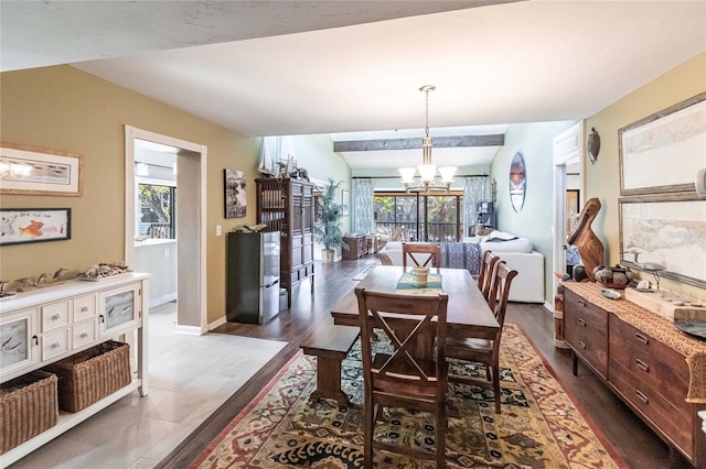 dining room featuring a chandelier, lofted ceiling, and hardwood / wood-style flooring