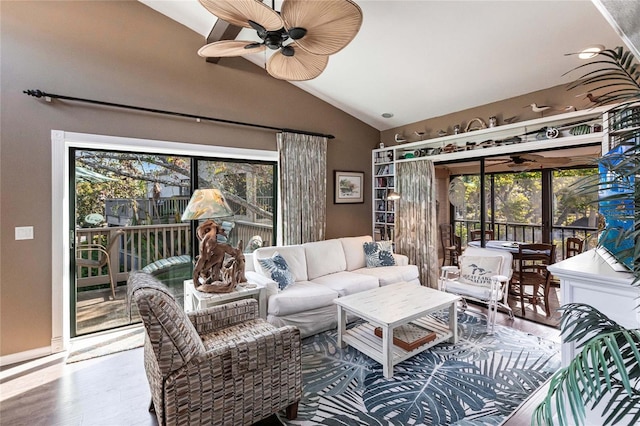 sunroom / solarium with lofted ceiling, ceiling fan, and a healthy amount of sunlight