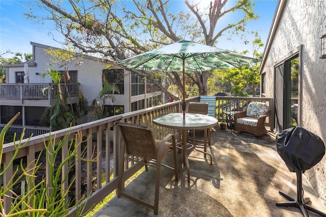 wooden balcony with a wooden deck and grilling area