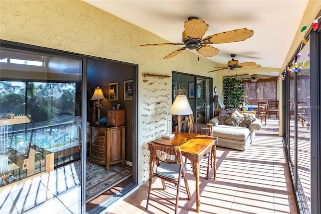 sunroom featuring vaulted ceiling and ceiling fan