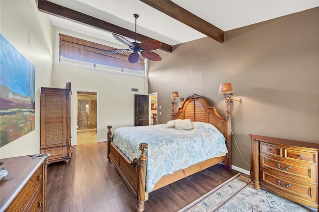 bedroom with baseboards, a high ceiling, beamed ceiling, ensuite bath, and wood finished floors