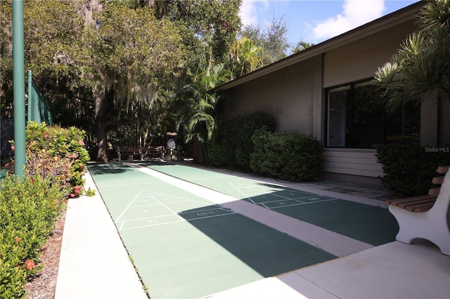 view of home's community featuring shuffleboard
