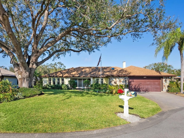 ranch-style house with a front yard and a garage