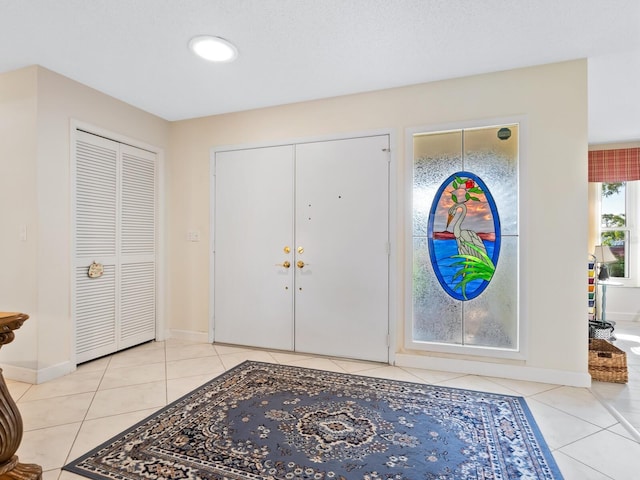 entryway featuring light tile patterned floors