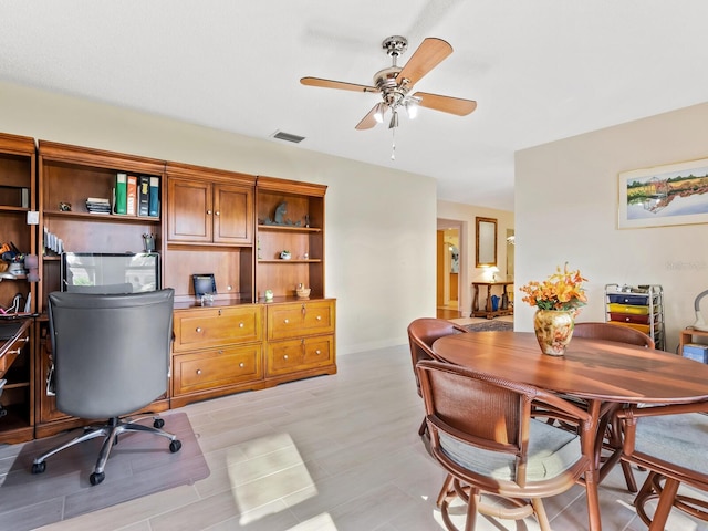 home office featuring ceiling fan and light hardwood / wood-style floors