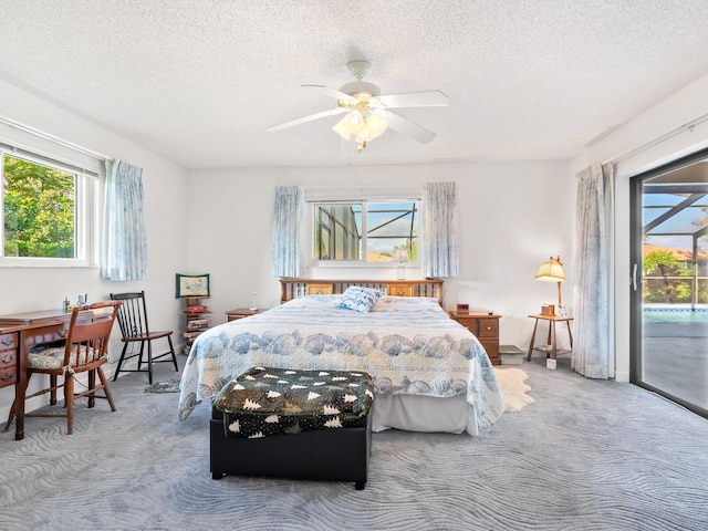 carpeted bedroom with a textured ceiling, access to outside, and ceiling fan