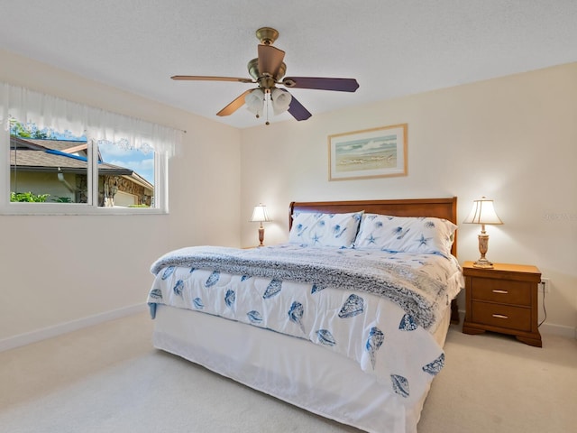 bedroom featuring ceiling fan and light colored carpet