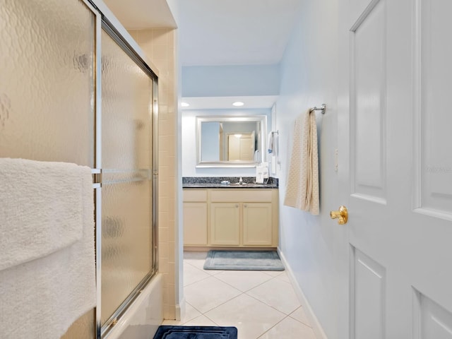 bathroom featuring tile patterned flooring, vanity, and shower / bath combination with glass door