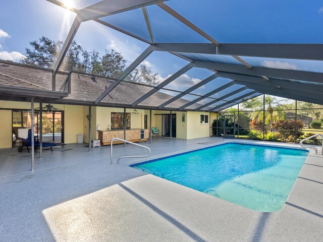 view of pool featuring a lanai, ceiling fan, and a patio