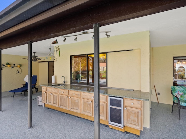 view of patio / terrace with area for grilling, ceiling fan, sink, and beverage cooler