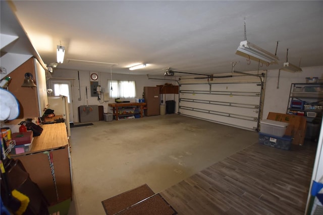 garage with electric panel and a garage door opener