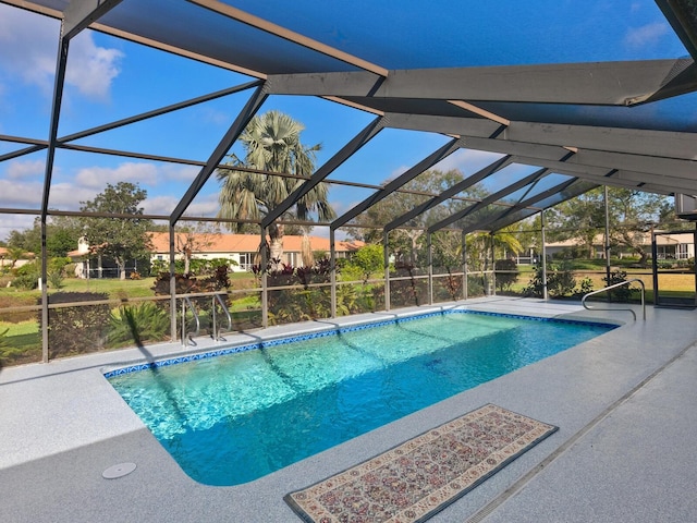 view of pool with a patio area and a lanai