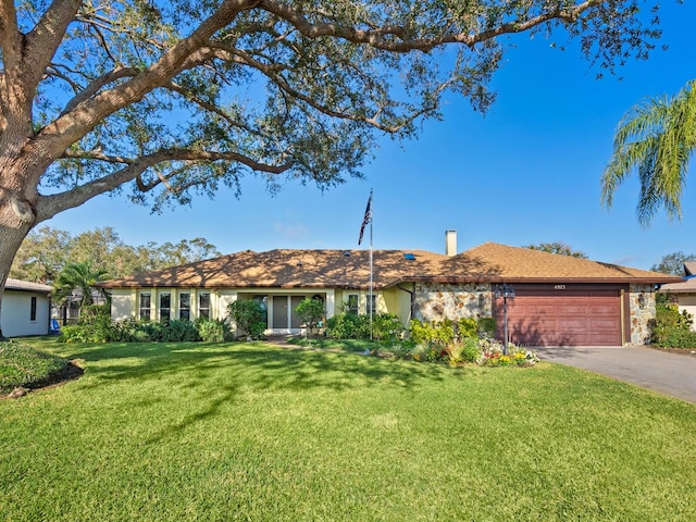 single story home with a front lawn and a garage