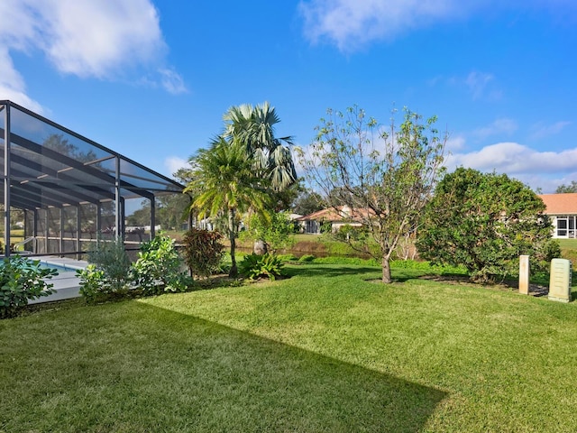 view of yard featuring glass enclosure