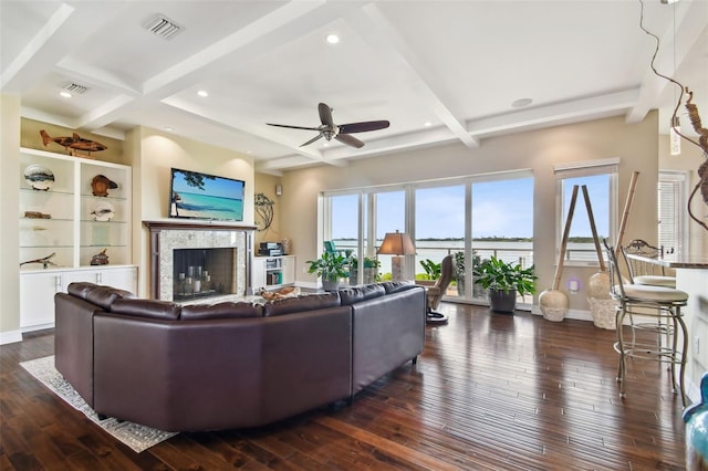 living room with ceiling fan, coffered ceiling, a premium fireplace, beamed ceiling, and dark hardwood / wood-style floors