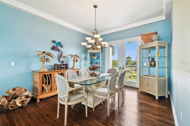 dining room featuring dark hardwood / wood-style flooring, crown molding, and french doors