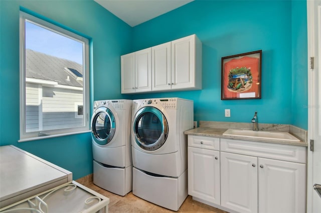 washroom with cabinets, independent washer and dryer, light tile patterned flooring, and sink