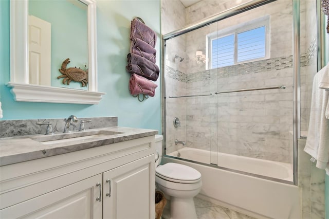 full bathroom with vanity, toilet, and combined bath / shower with glass door