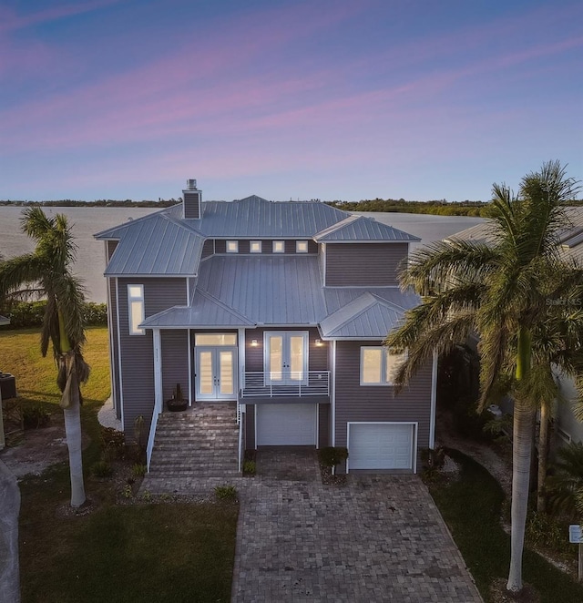 view of front of home with french doors and a balcony