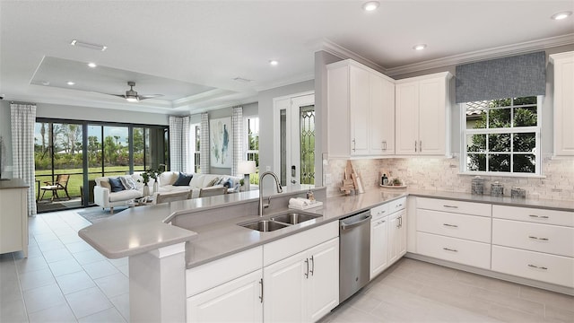 kitchen featuring stainless steel dishwasher, white cabinetry, kitchen peninsula, and sink