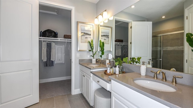 bathroom featuring tile patterned flooring, vanity, and an enclosed shower