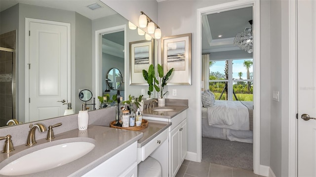 bathroom featuring tile patterned flooring, vanity, and crown molding