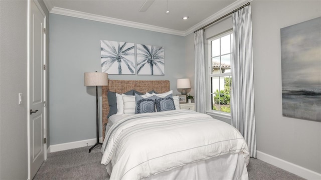 carpeted bedroom with ceiling fan and ornamental molding