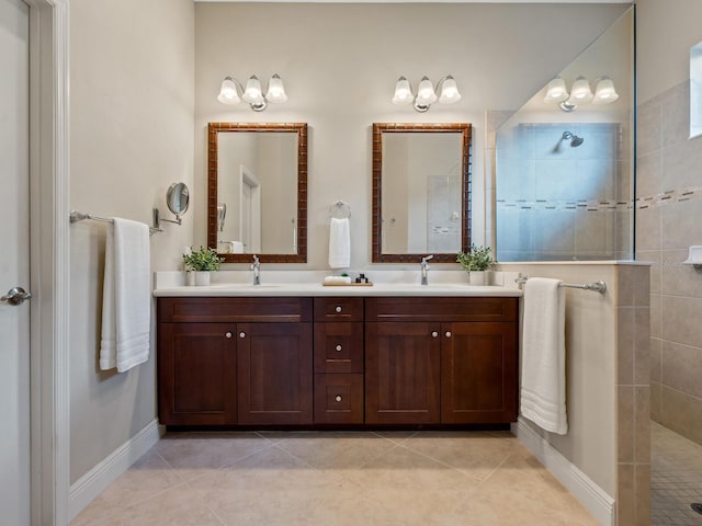 bathroom featuring tile patterned flooring, vanity, and tiled shower