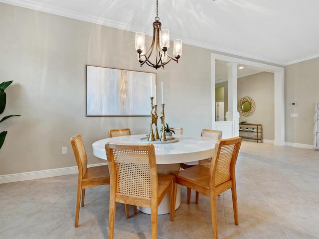 dining room with a chandelier, decorative columns, and ornamental molding