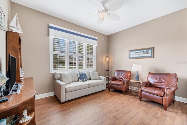 living room with ceiling fan and light hardwood / wood-style flooring