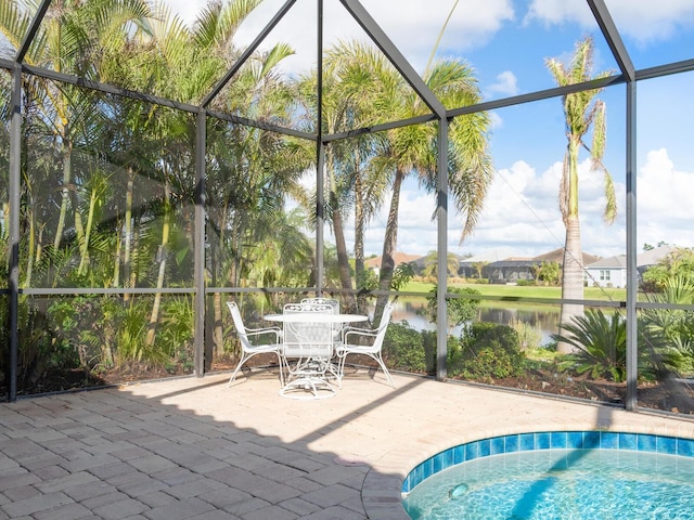 exterior space featuring a lanai and a water view