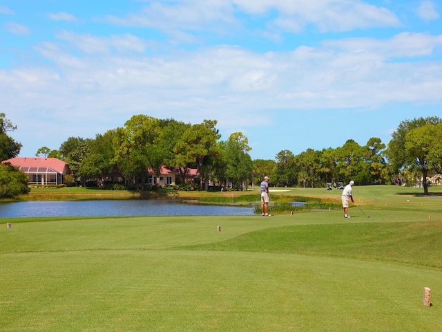 view of property's community with a yard and a water view