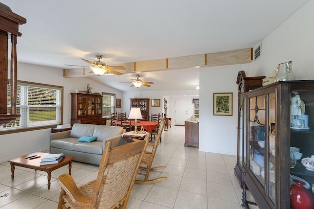 living room featuring ceiling fan, lofted ceiling with beams, and light tile patterned floors