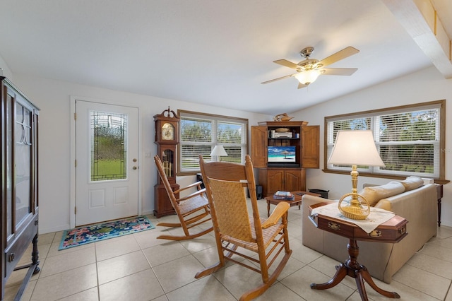 living room featuring light tile patterned flooring, a wealth of natural light, and vaulted ceiling