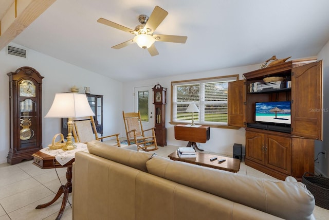 living room featuring ceiling fan, light tile patterned floors, and lofted ceiling