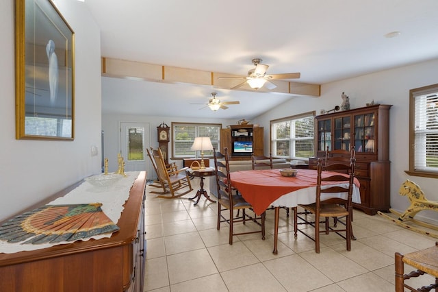 tiled dining room with ceiling fan and lofted ceiling