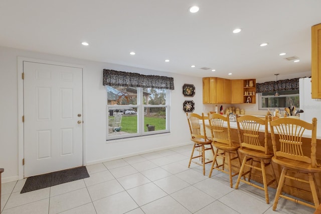 tiled dining space featuring indoor bar