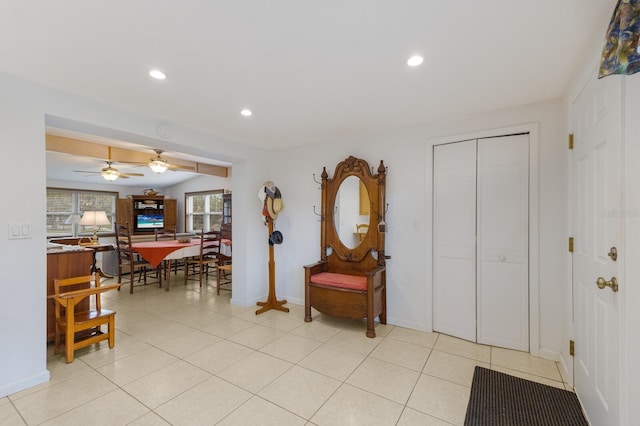 foyer entrance with ceiling fan and light tile patterned floors